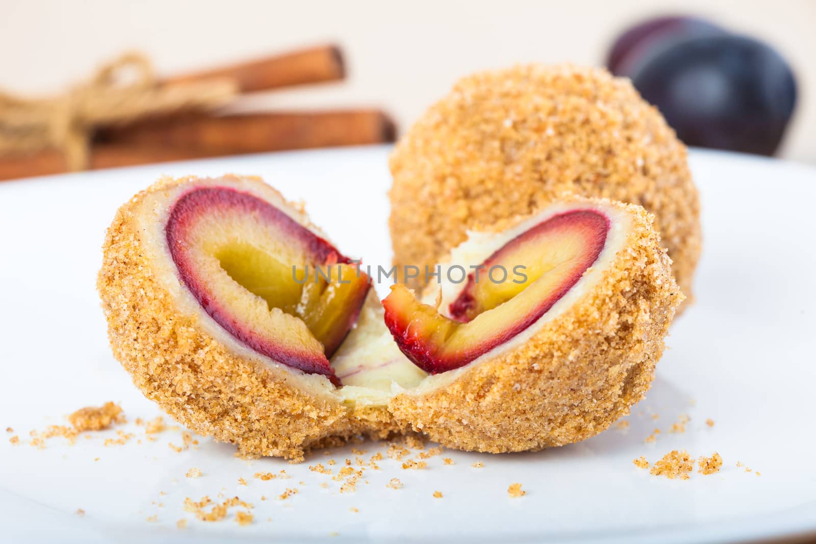 Close up of delicious sweet plum dumplings on white plate
