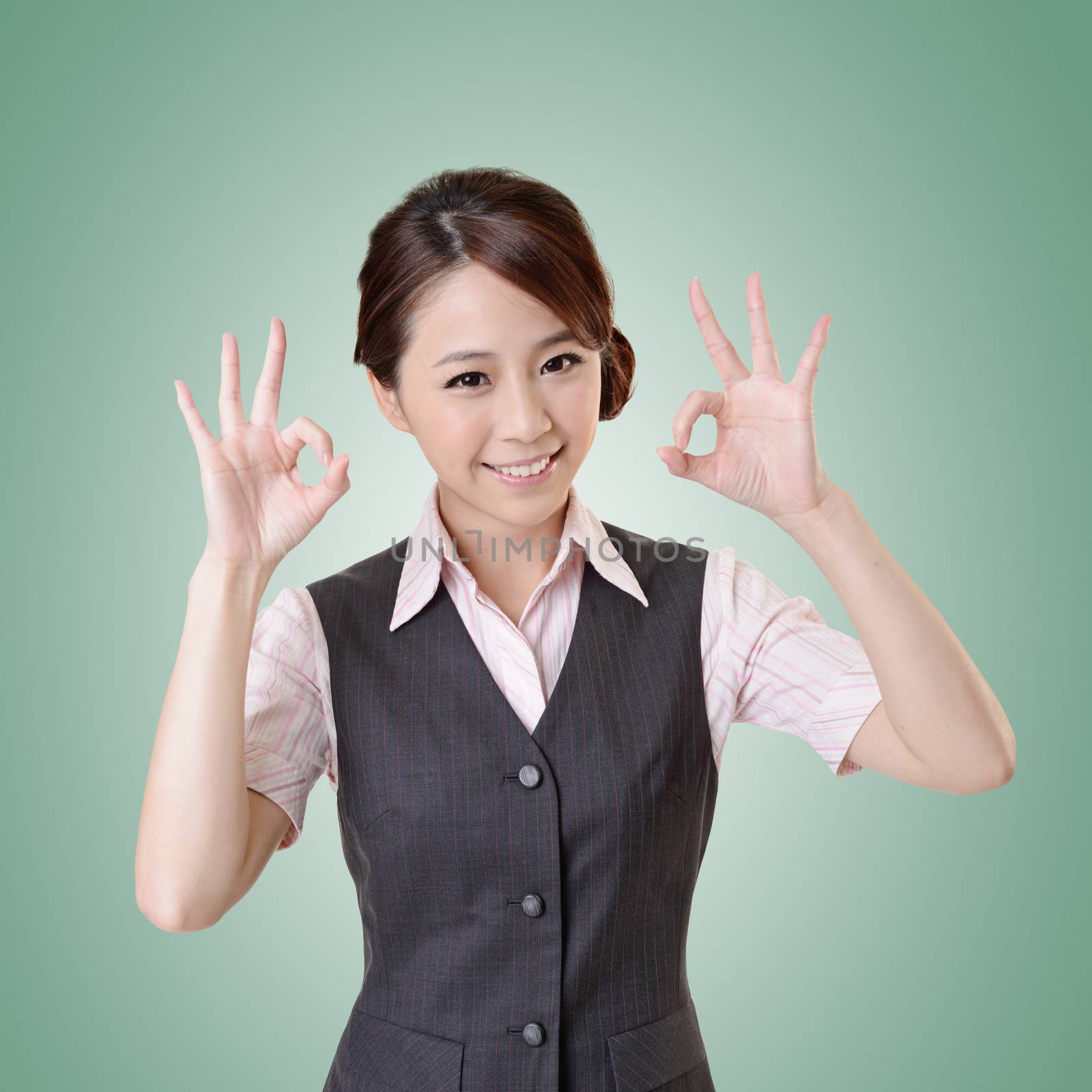 Asian business woman give you OK gesture, close up portrait with clipping path.