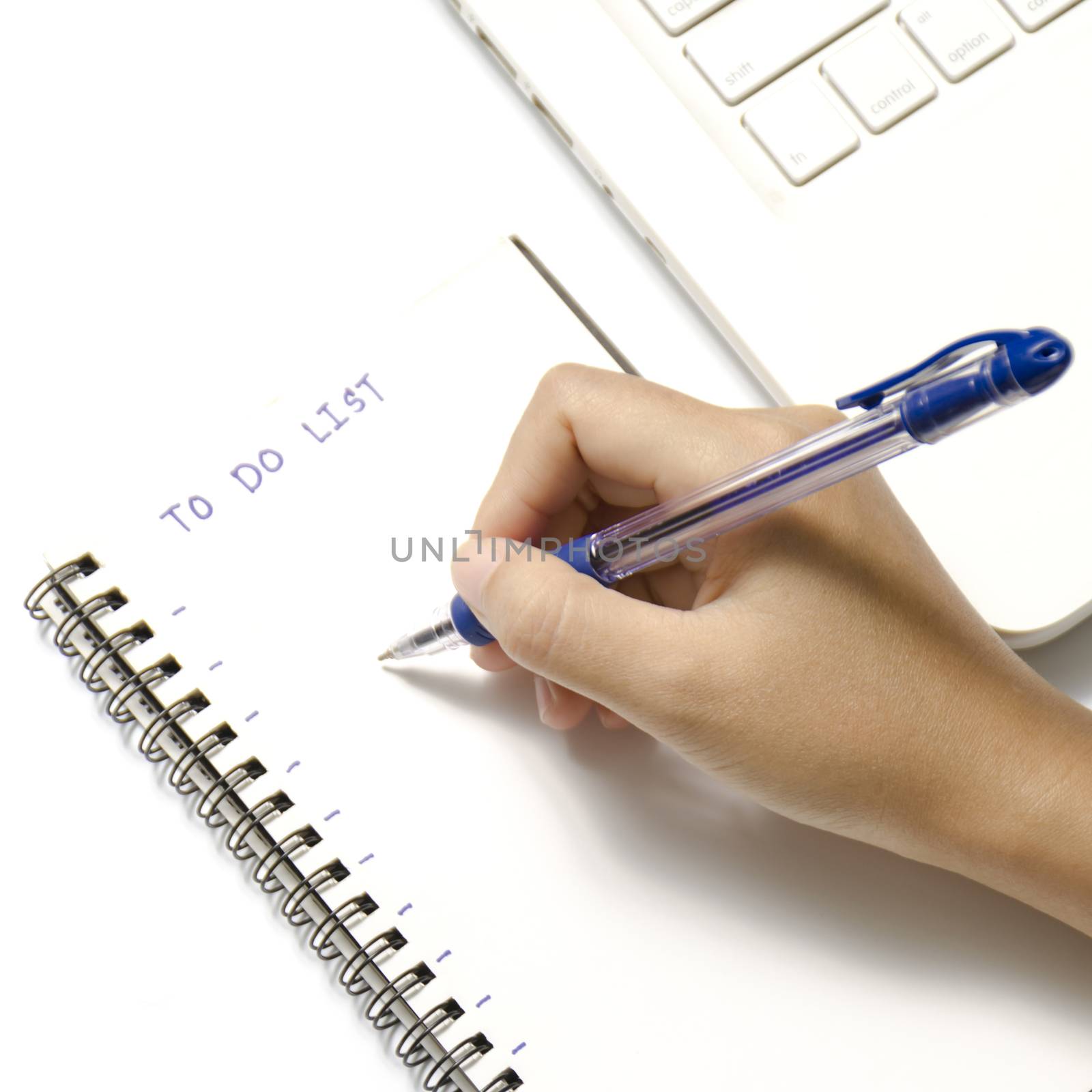 woman hand writing with pen on notebook write to do word and laptop over white background
