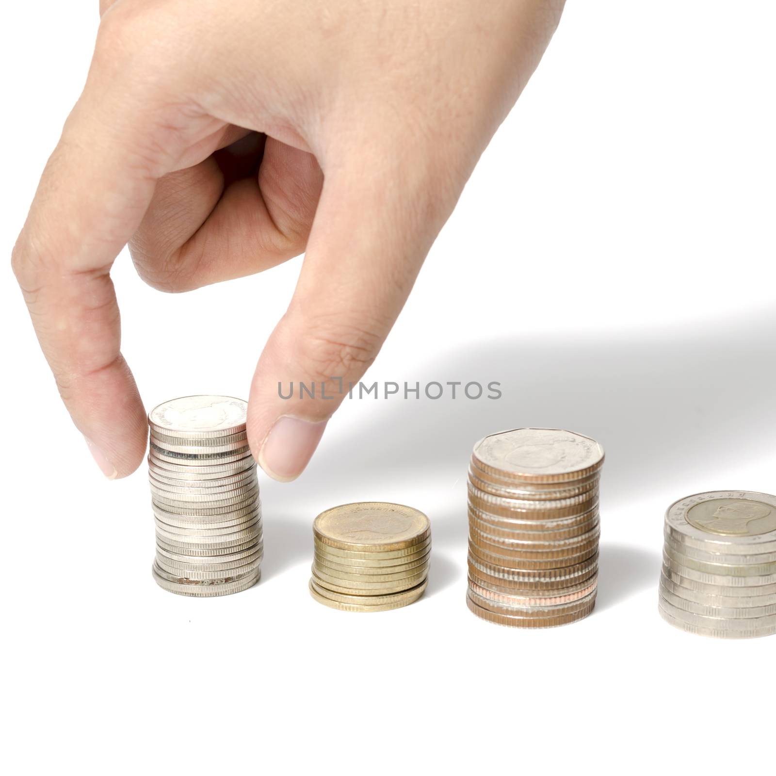 woman hand putting stack of coins on a white background