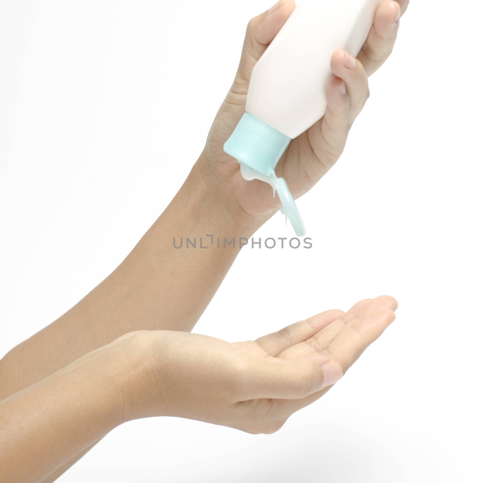 woman pouring body lotion on hand isolated on white background