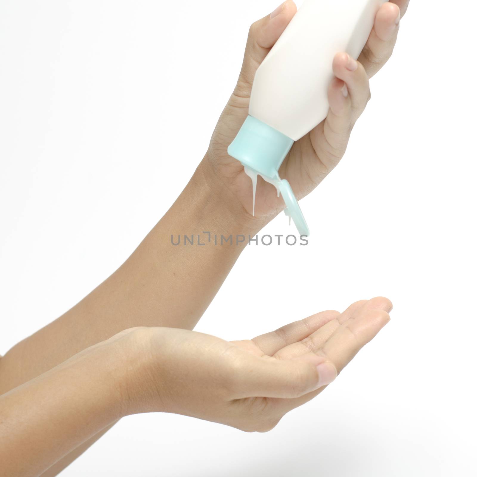 woman pouring body lotion on hand isolated on white background