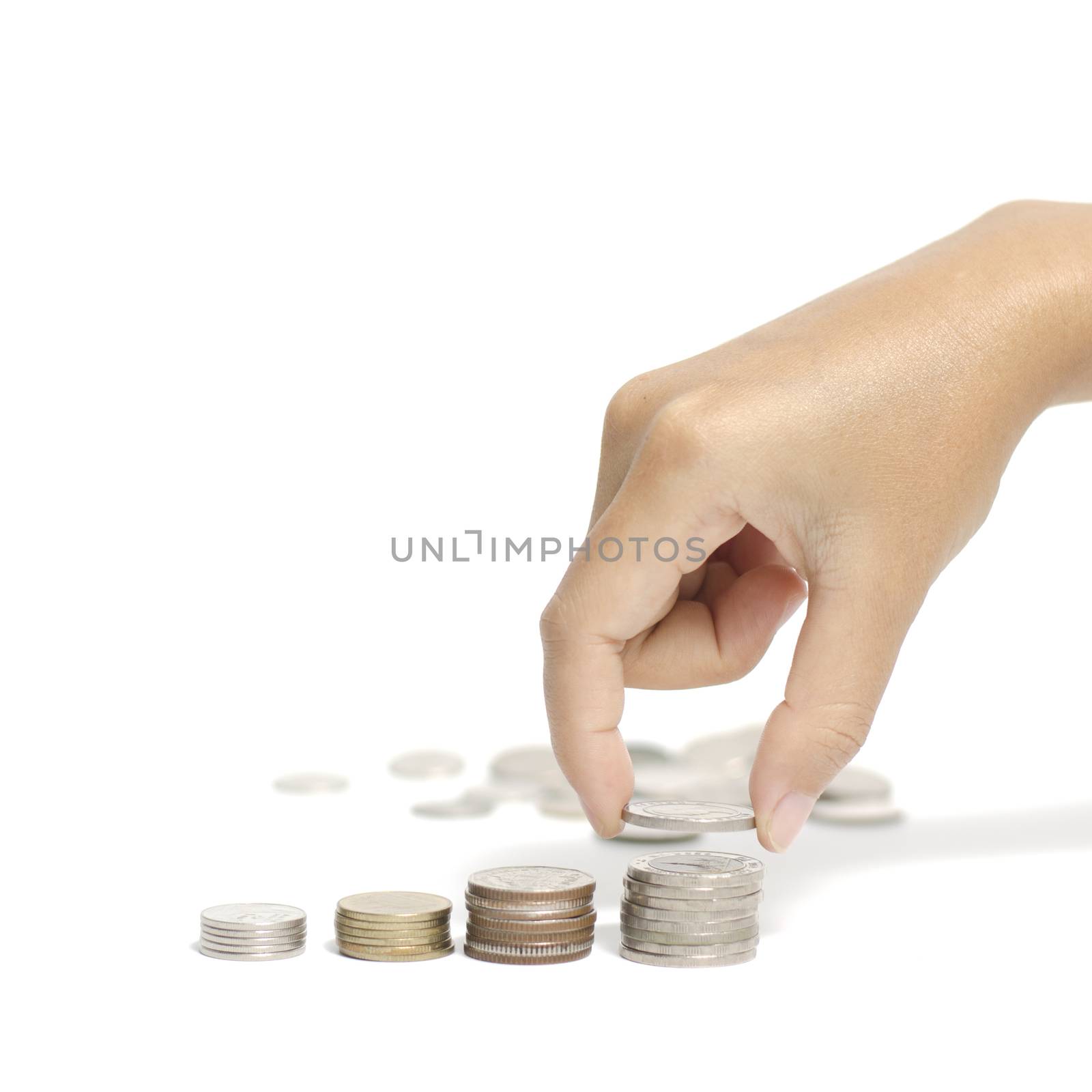 woman hand putting stack of coins on a white background