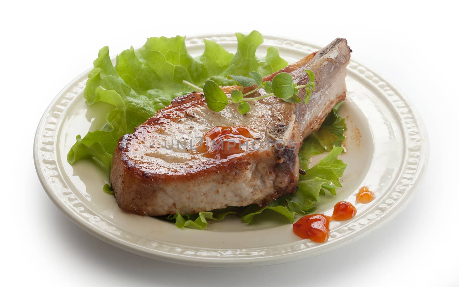 Fried pork cutlet with fresh green lettuce on the plate