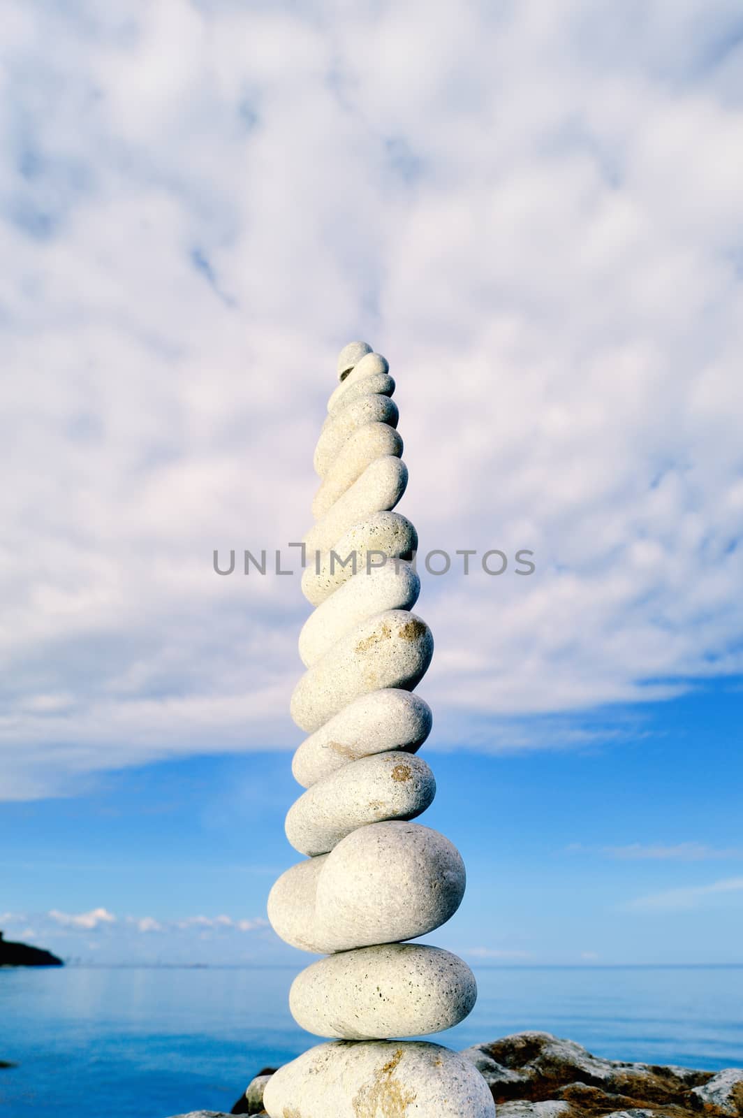 Balancing of white pebbles each other on the seacoast