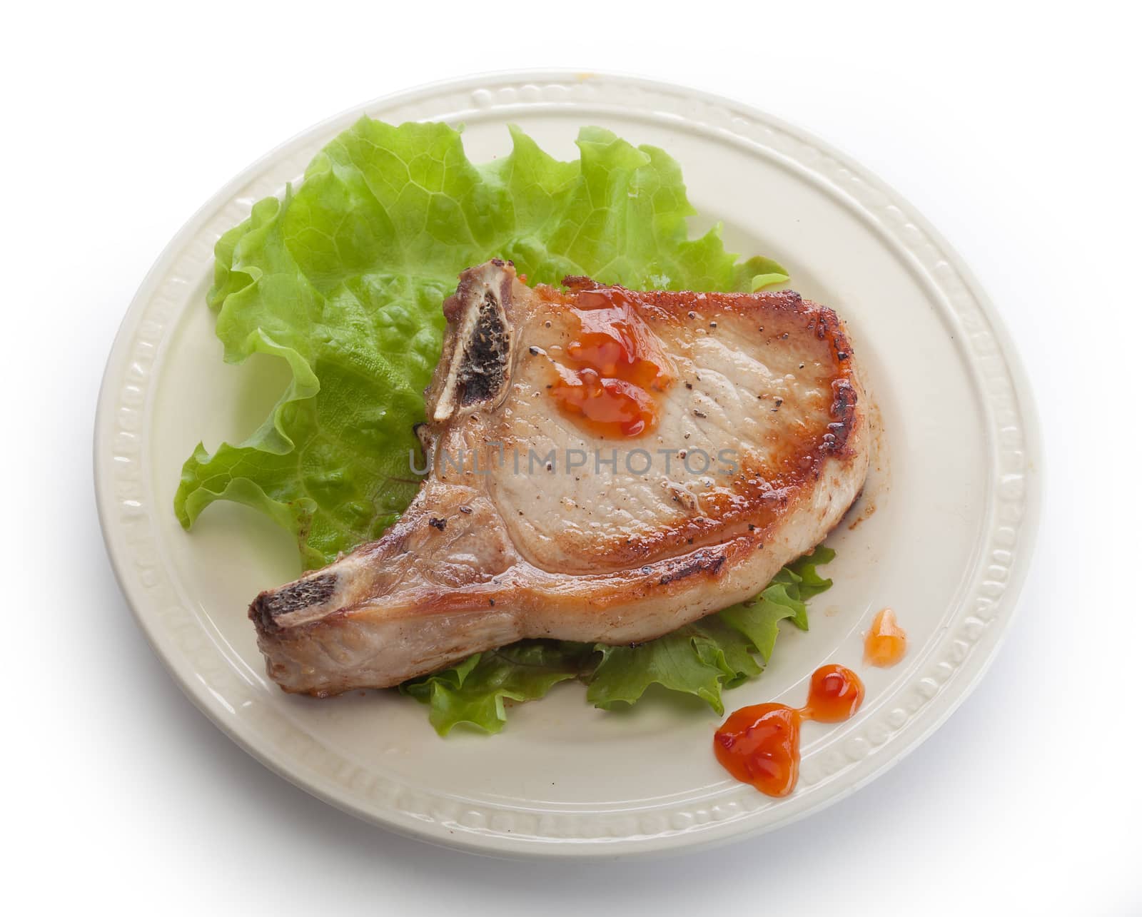 Fried pork cutlet with fresh green lettuce on the plate