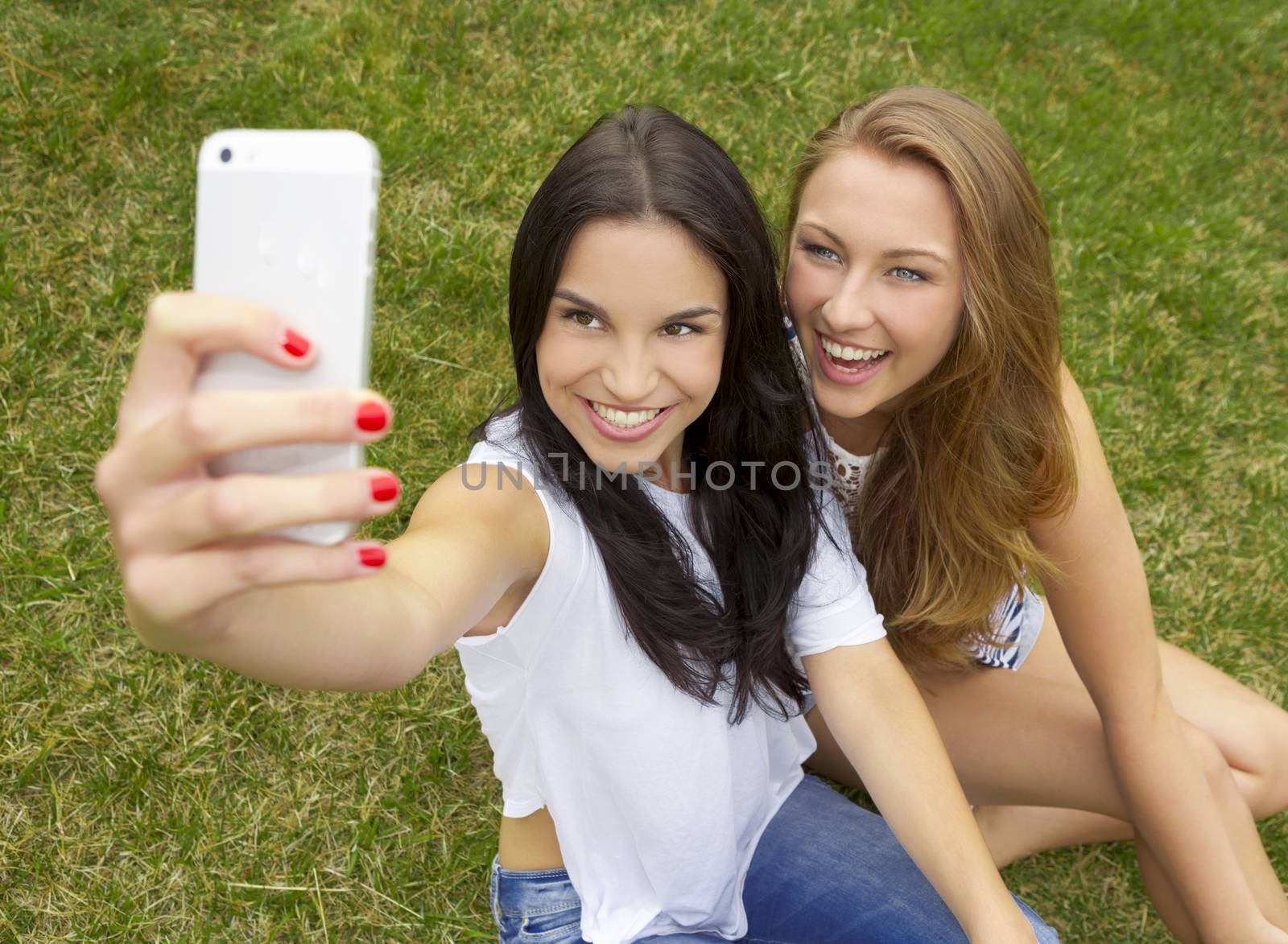 Beautiful and happy teenagers taking selfies
