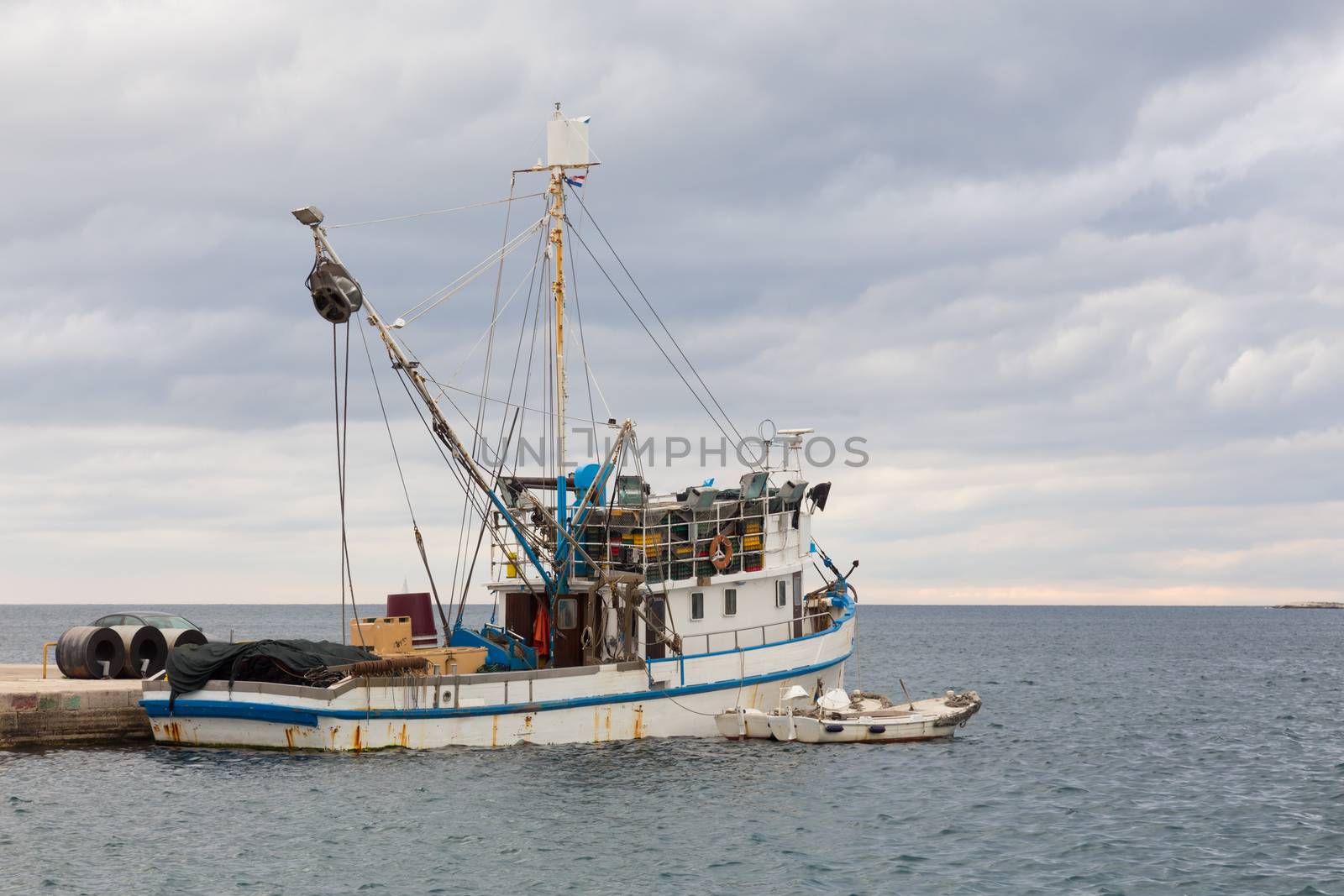 Old rusty fishing boat moored in the harbour.