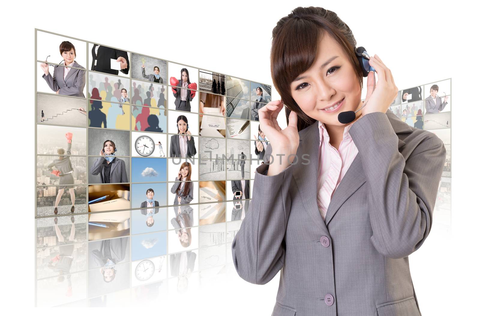 Business woman with headphone standing in front of TV screen wall.