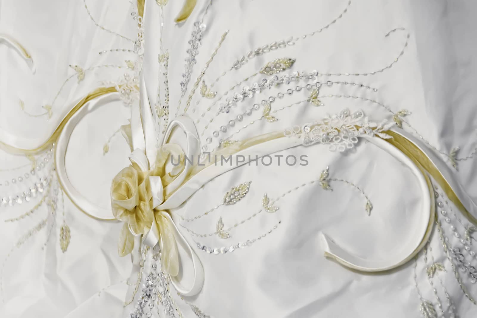 Texture of white, sequined wedding gown with flower