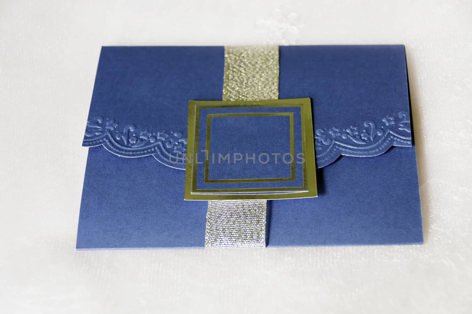 Royal blue invitation shot against bride's white veil