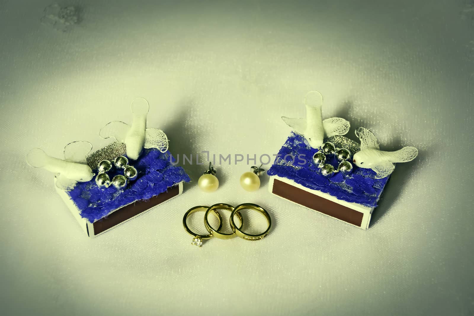 Various bride groom wedding accessories on of of bride's veil