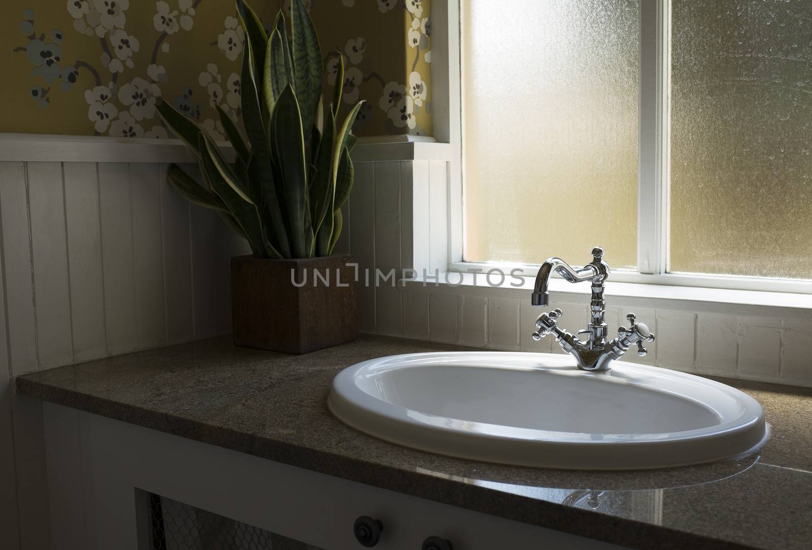 Old retro water tap basin in modern bathroom toilet with window