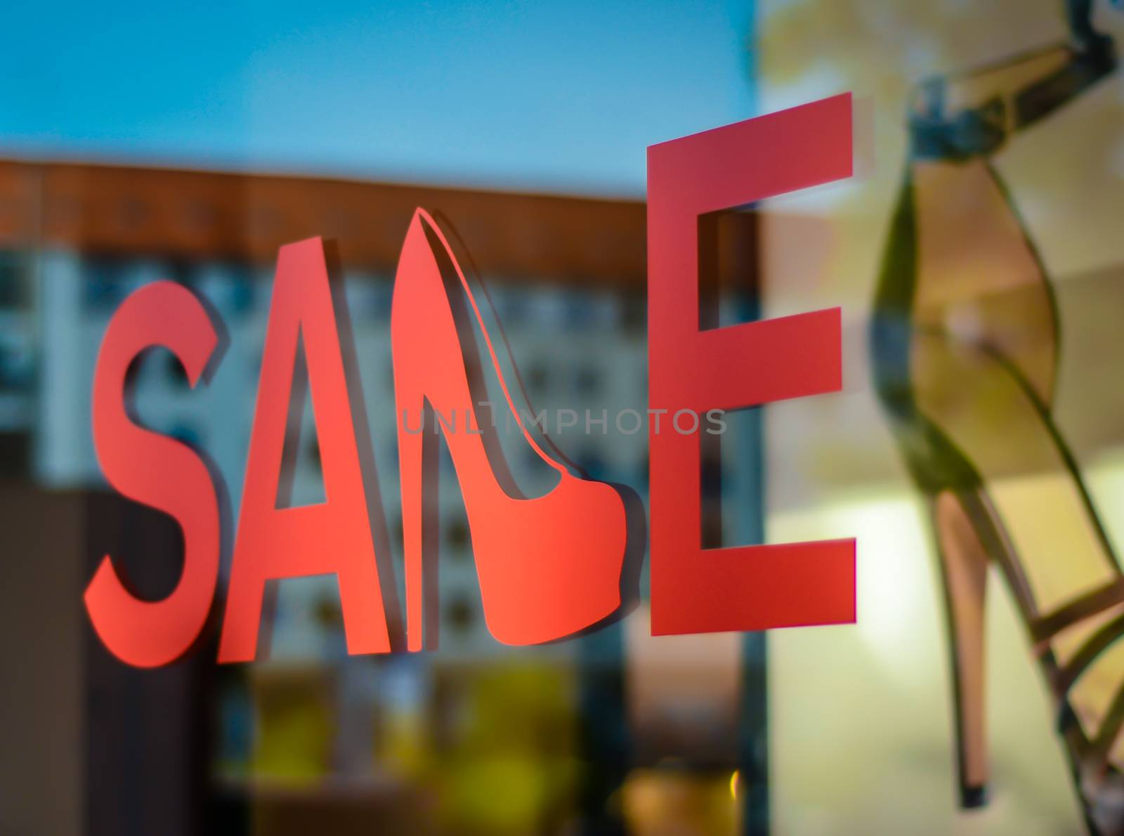 A Sale Sign In A Shoe Store Window