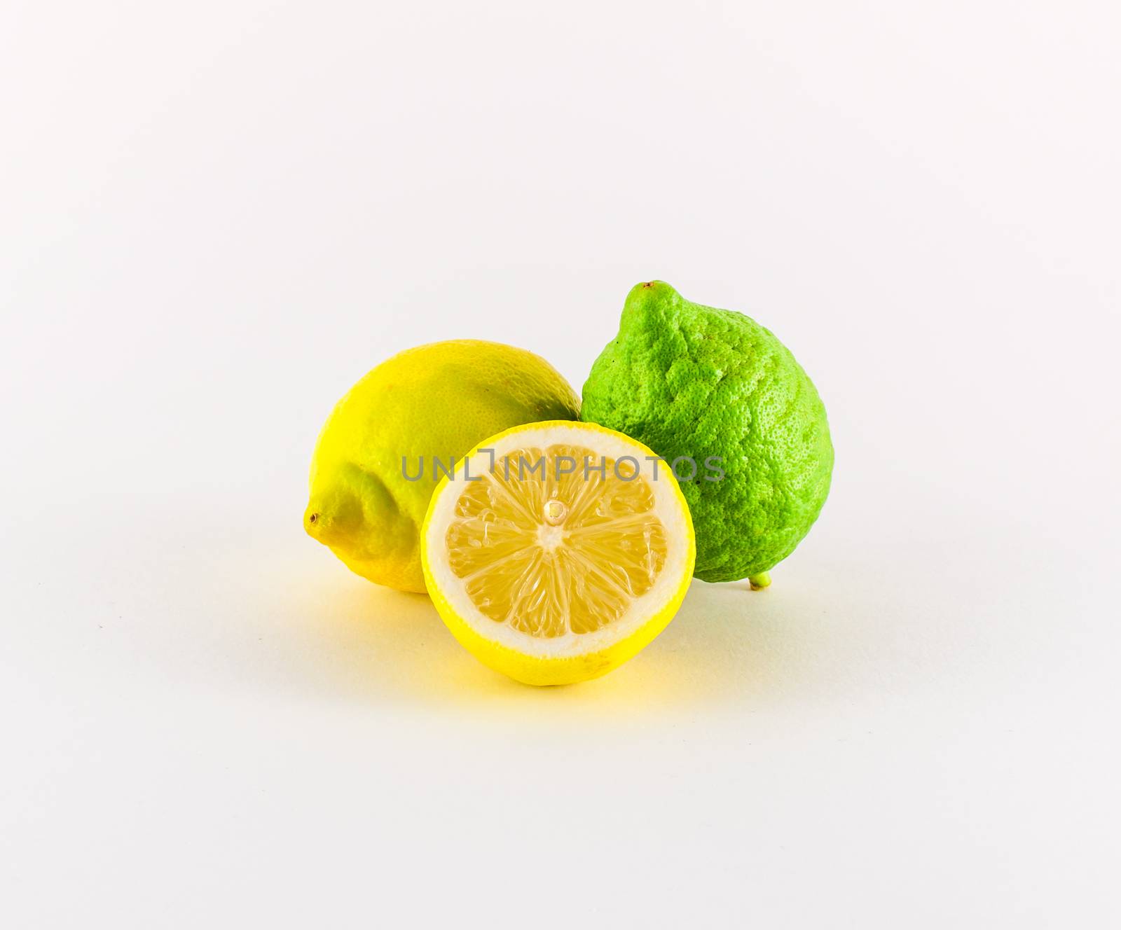 Fresh lemons yellow and green on white background