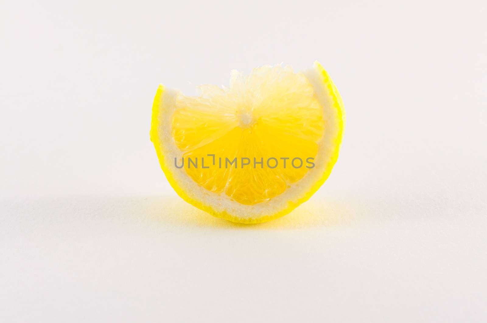 Slice of fresh lemon yellow on white background