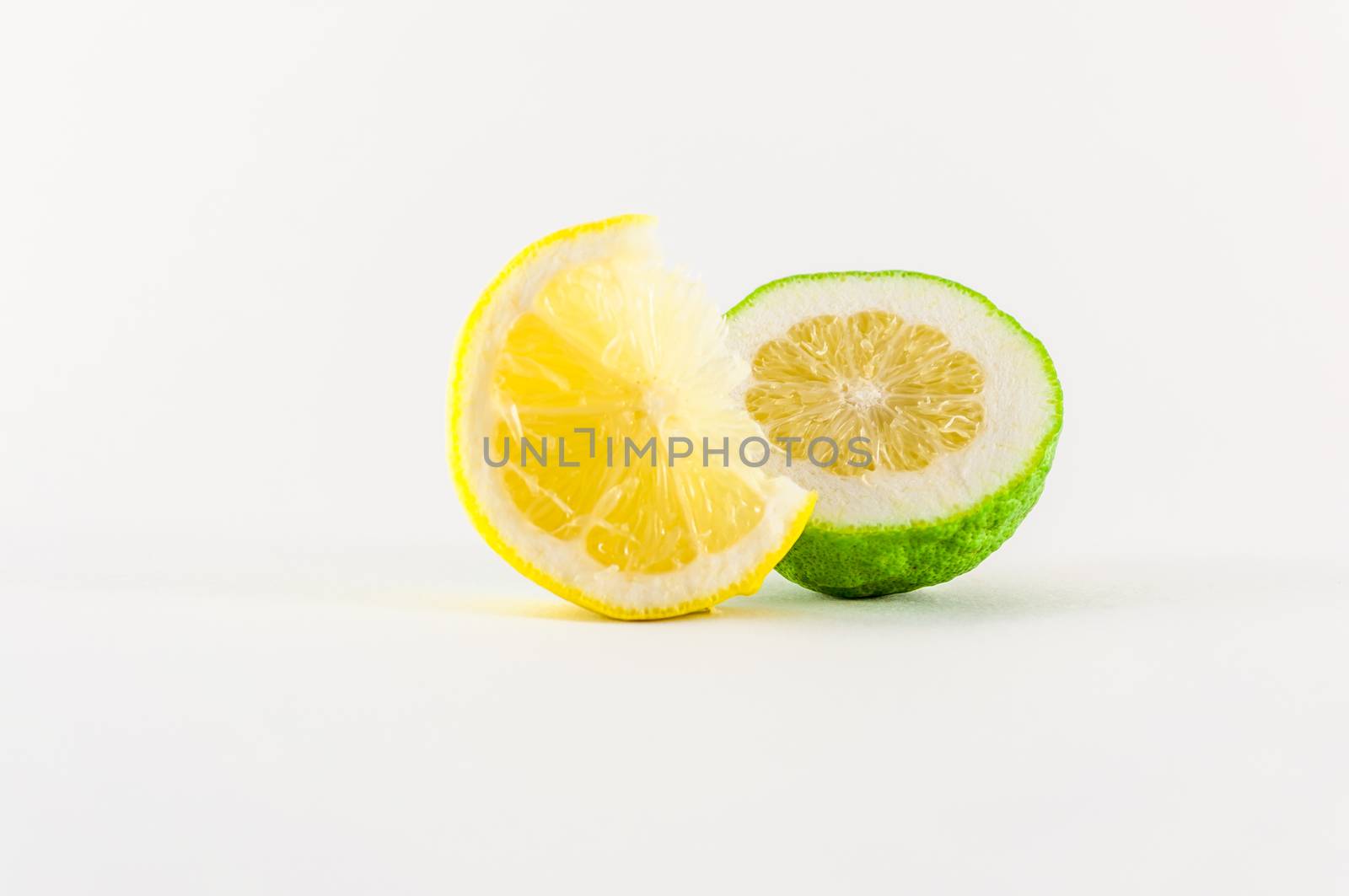 Slice of fresh lemon yellow on white background