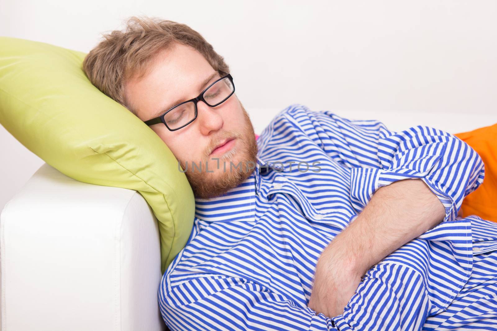 Young man sleeping on the couch - studio shoot 