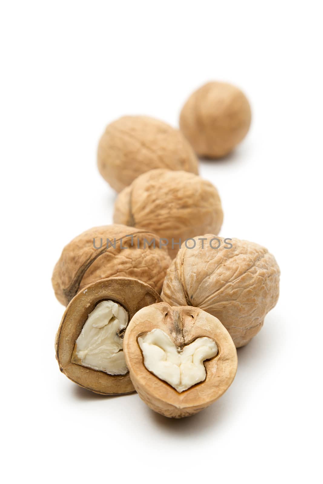 Heap of walnuts on white by Garsya