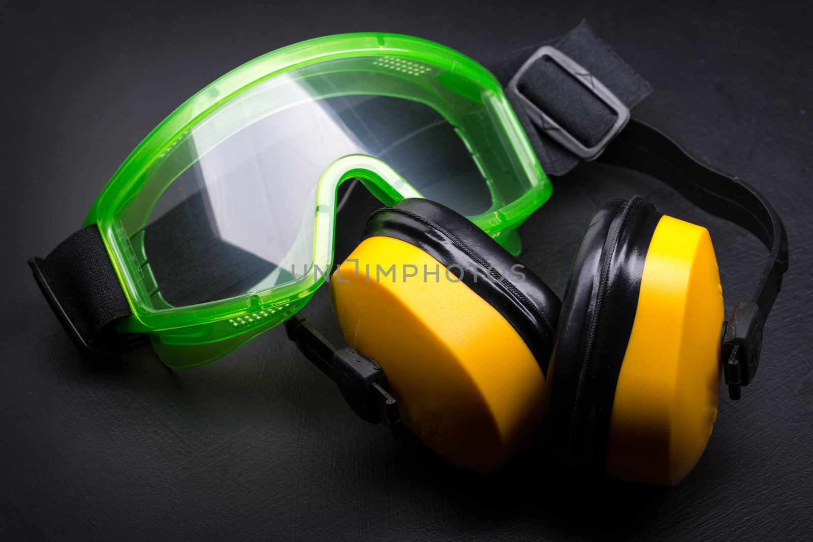 Green goggles with earphones on black