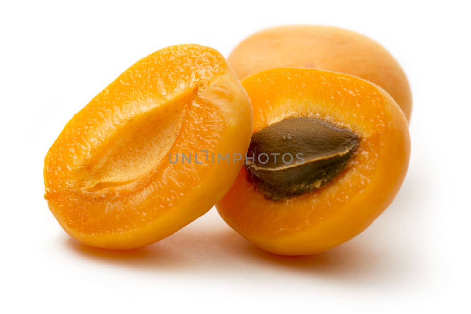 Ripe apricots on white background