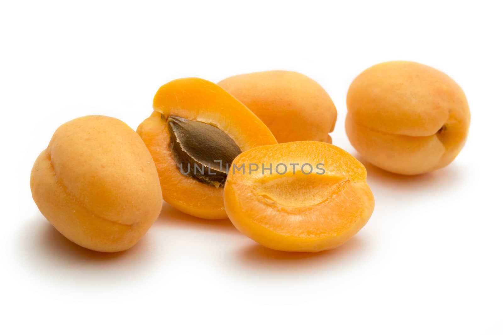Ripe apricots on white background