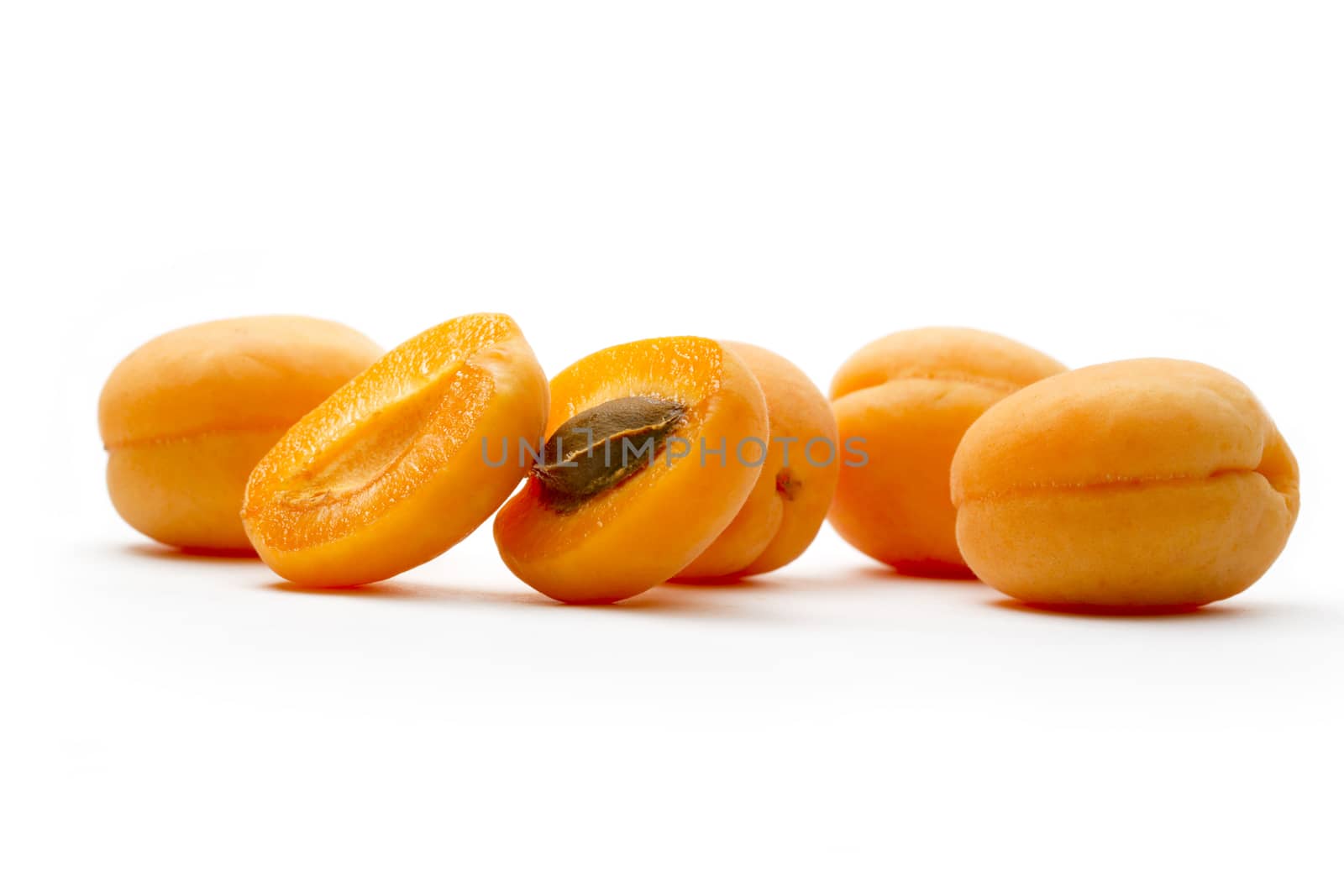 Ripe apricots on white background