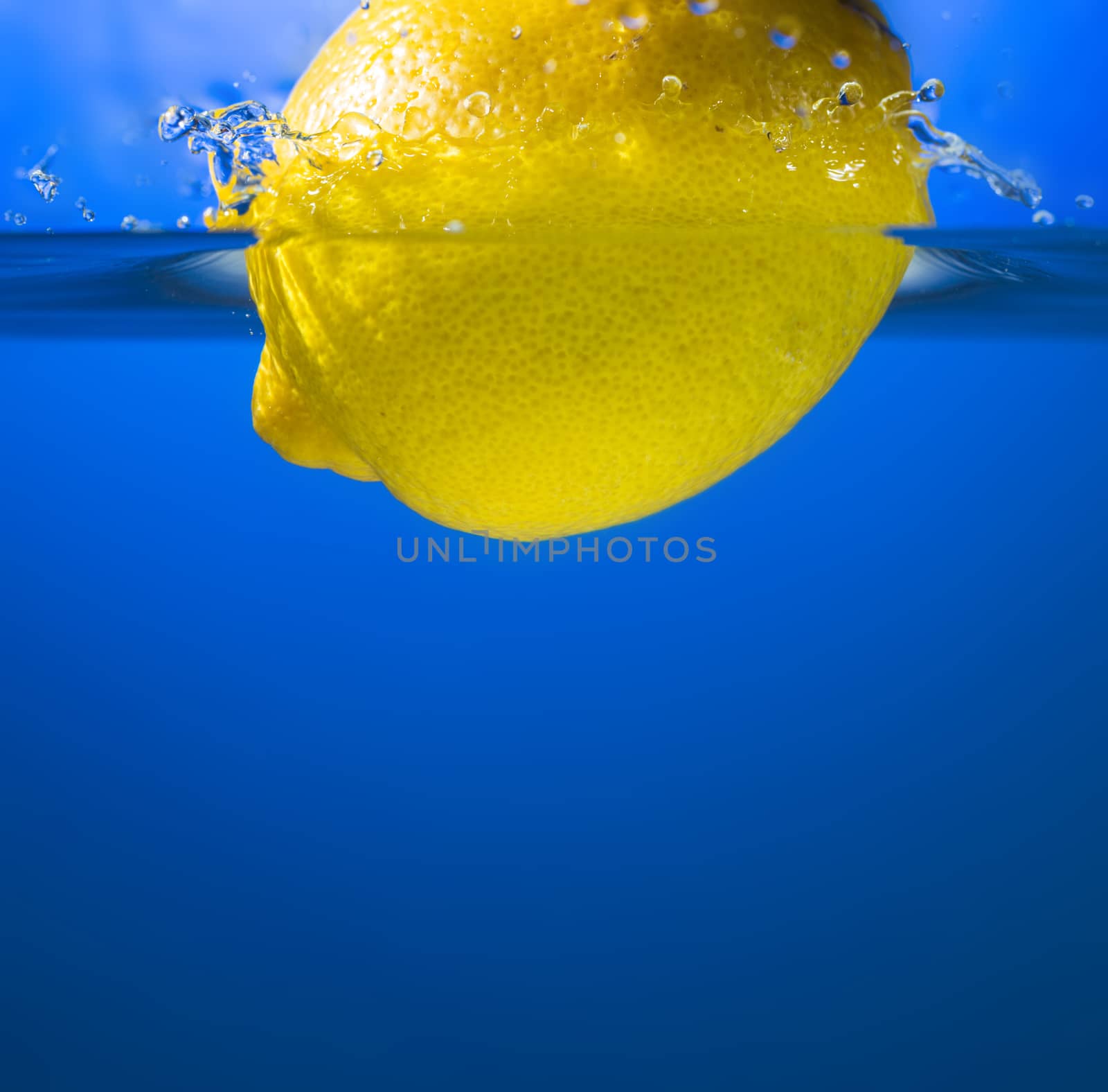 Yellow lemon in water splash