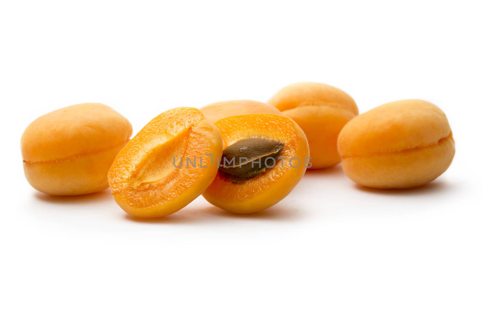 Ripe apricots on white background by Garsya