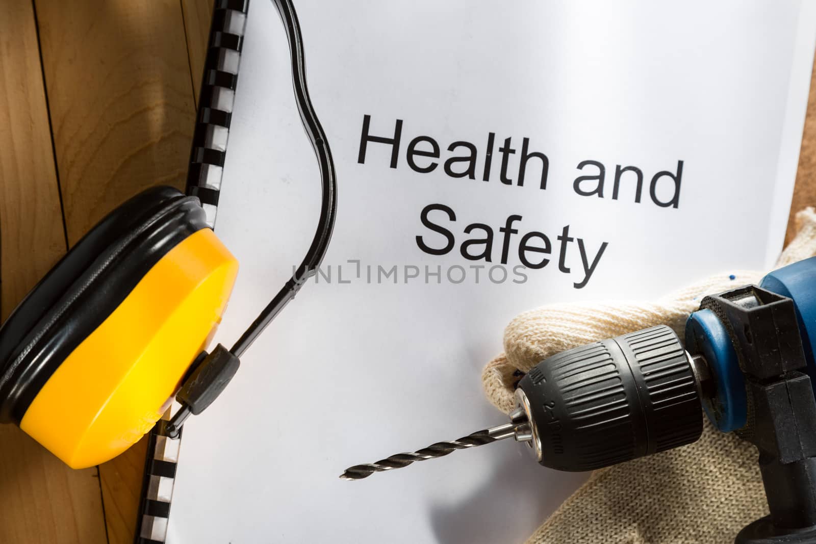 Register with drill and gloves on wooden background