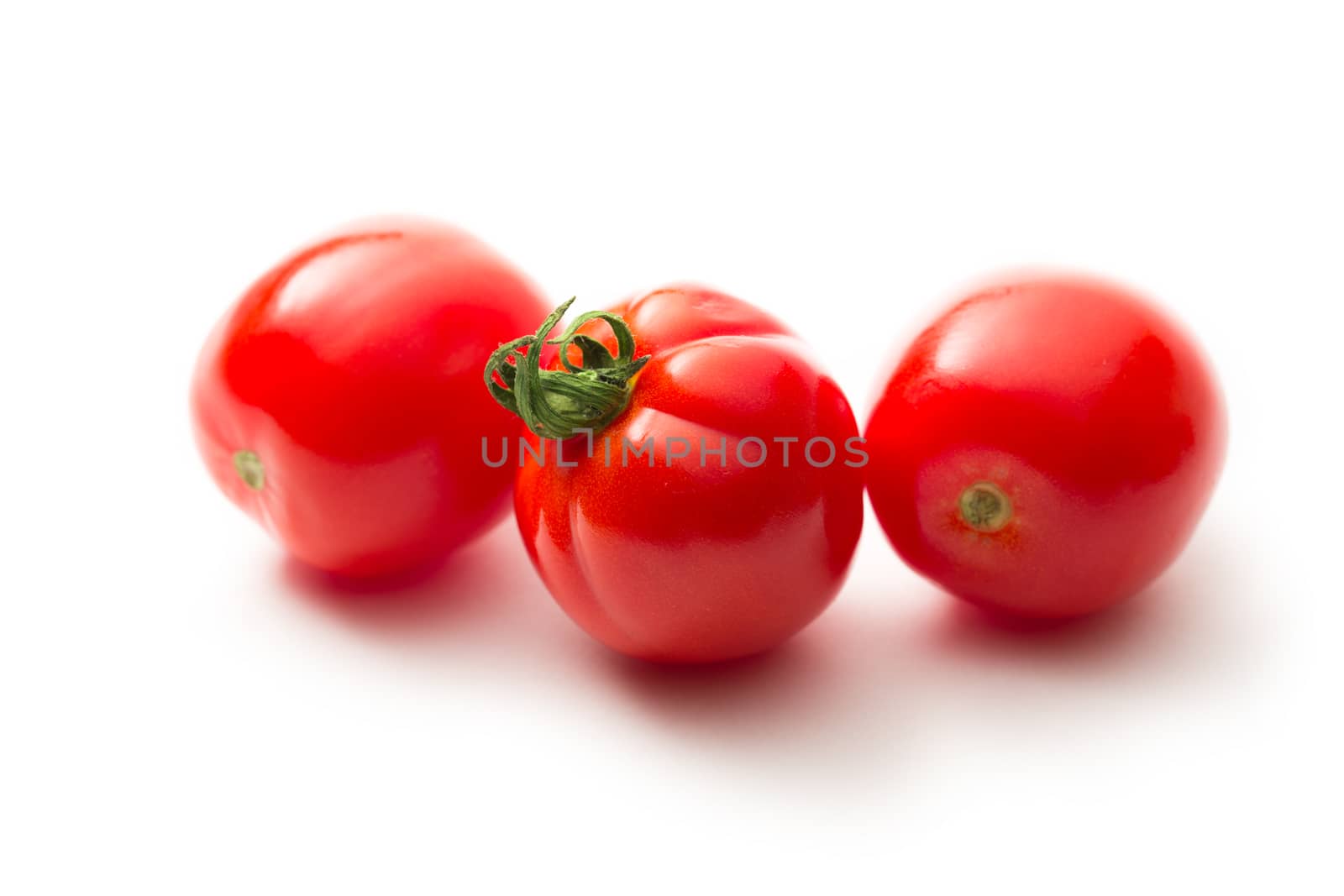 Fresh tomatoes on white by Garsya