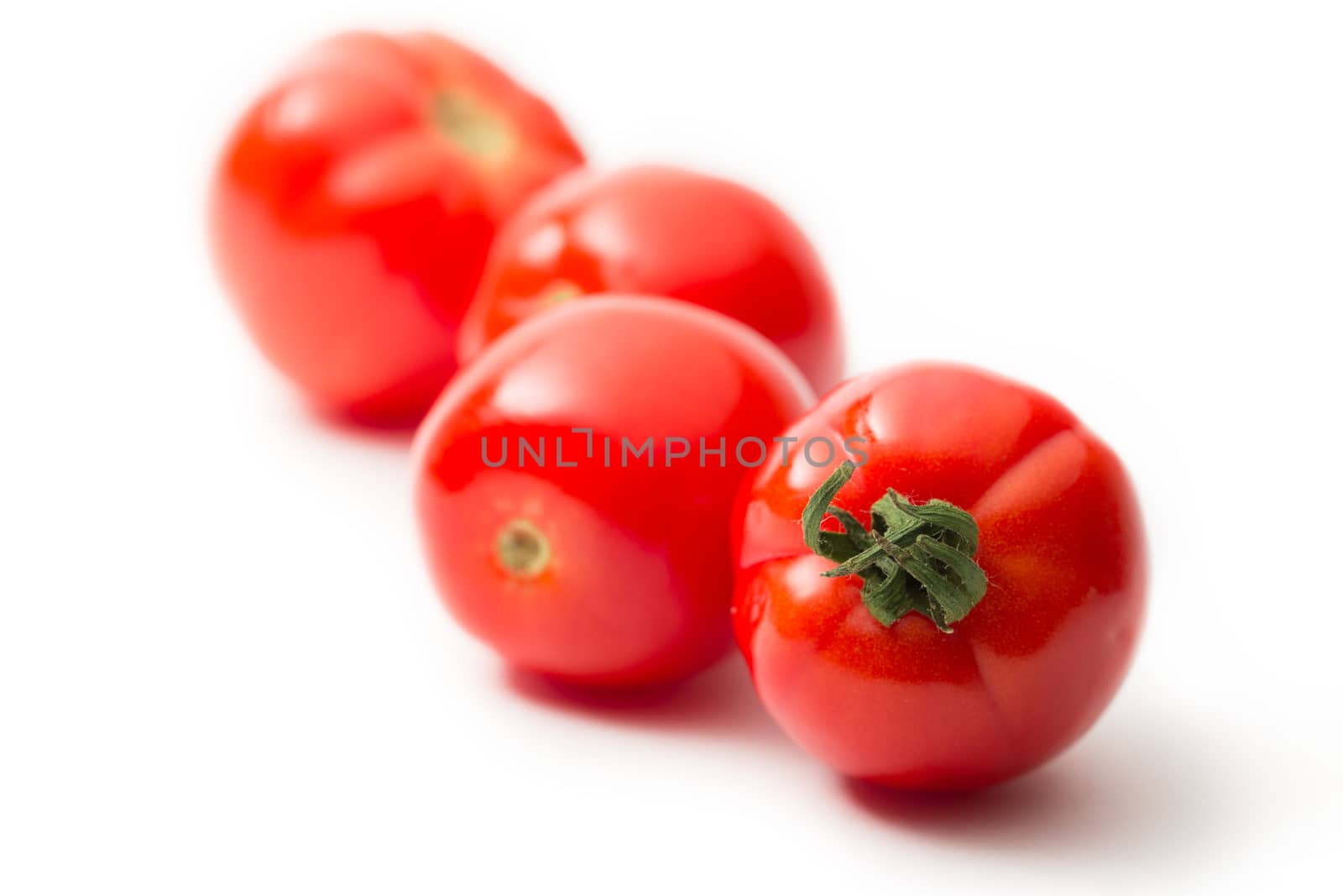 Fresh tomatoes on white