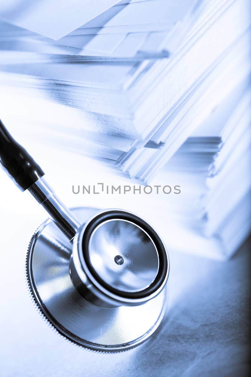 Stethoscope and heap of paper cards