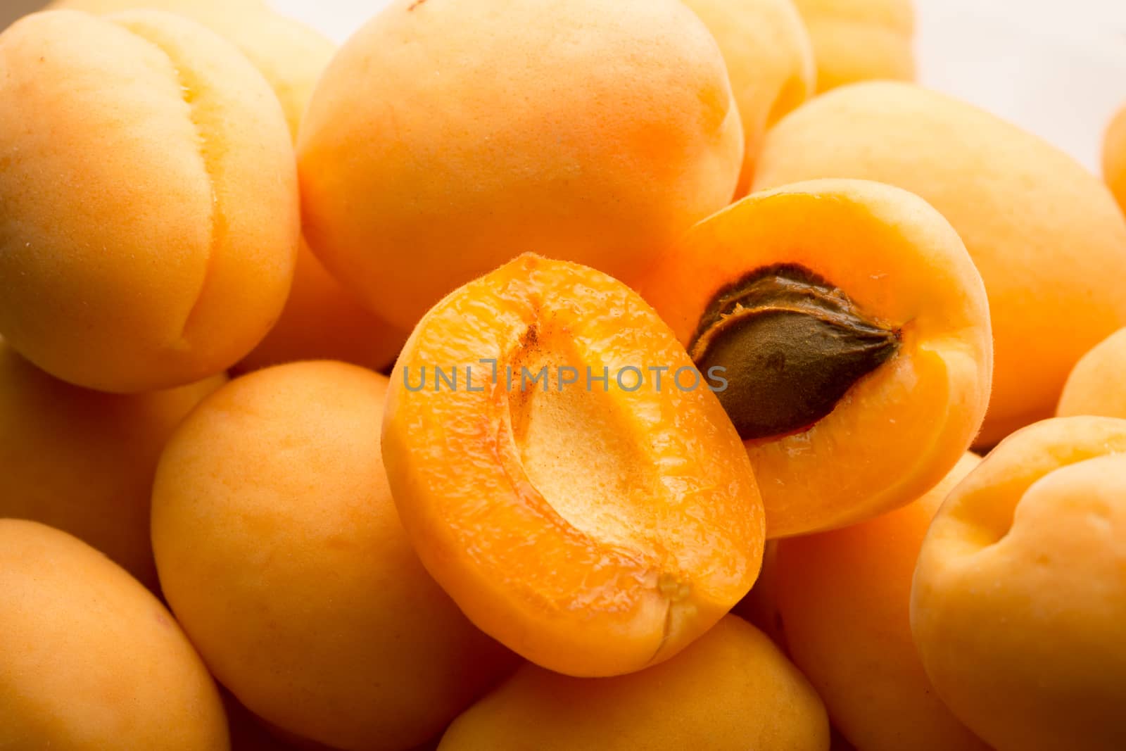 Ripe apricots on white background by Garsya