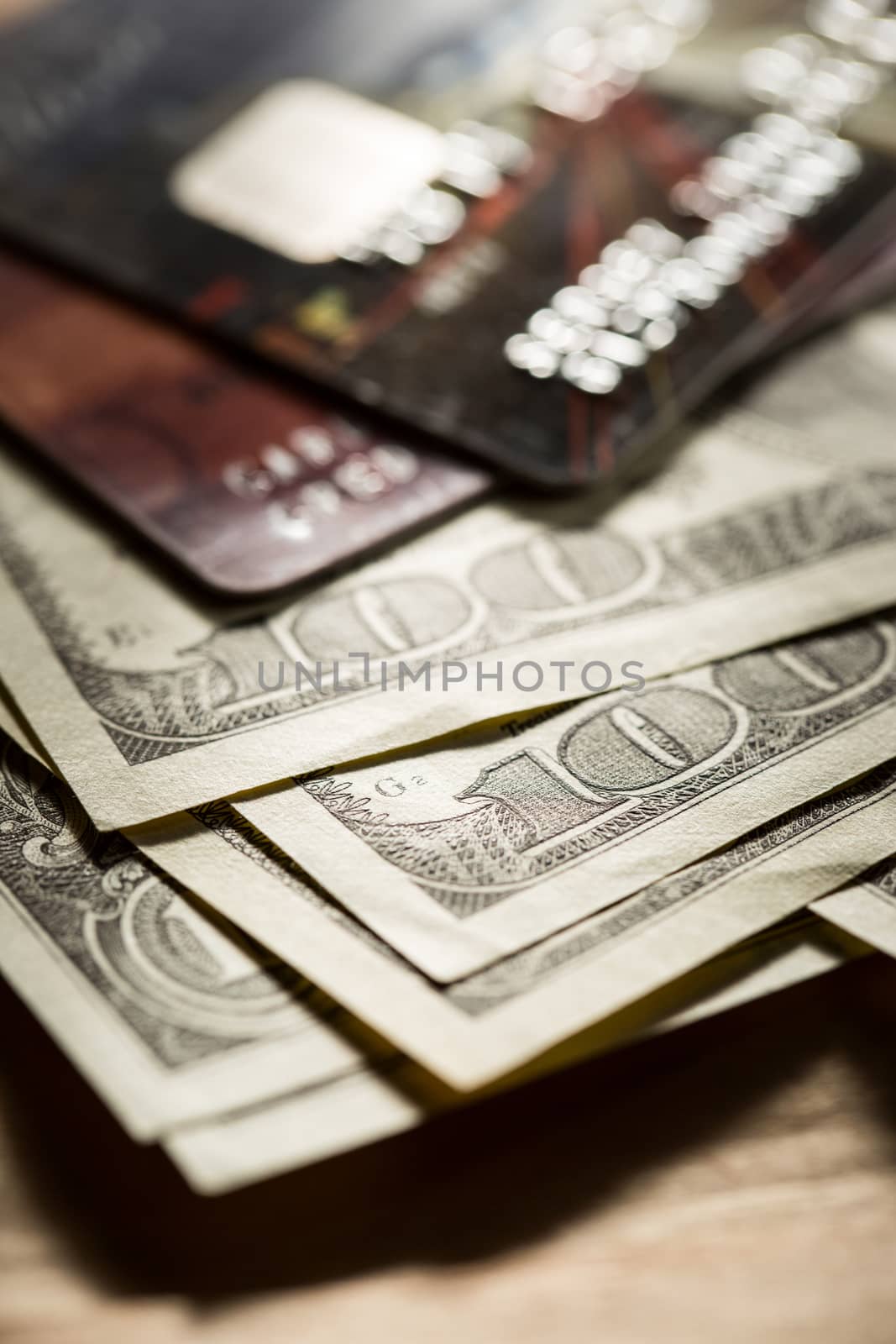 Credit cards and dollars in cash by Garsya
