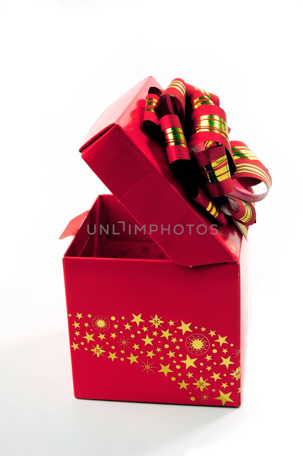 A red gift box with a red bow and gold