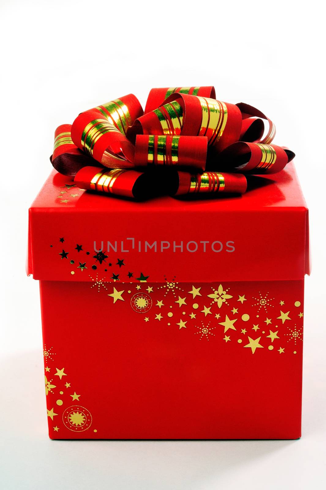 A red gift box with a red bow and gold