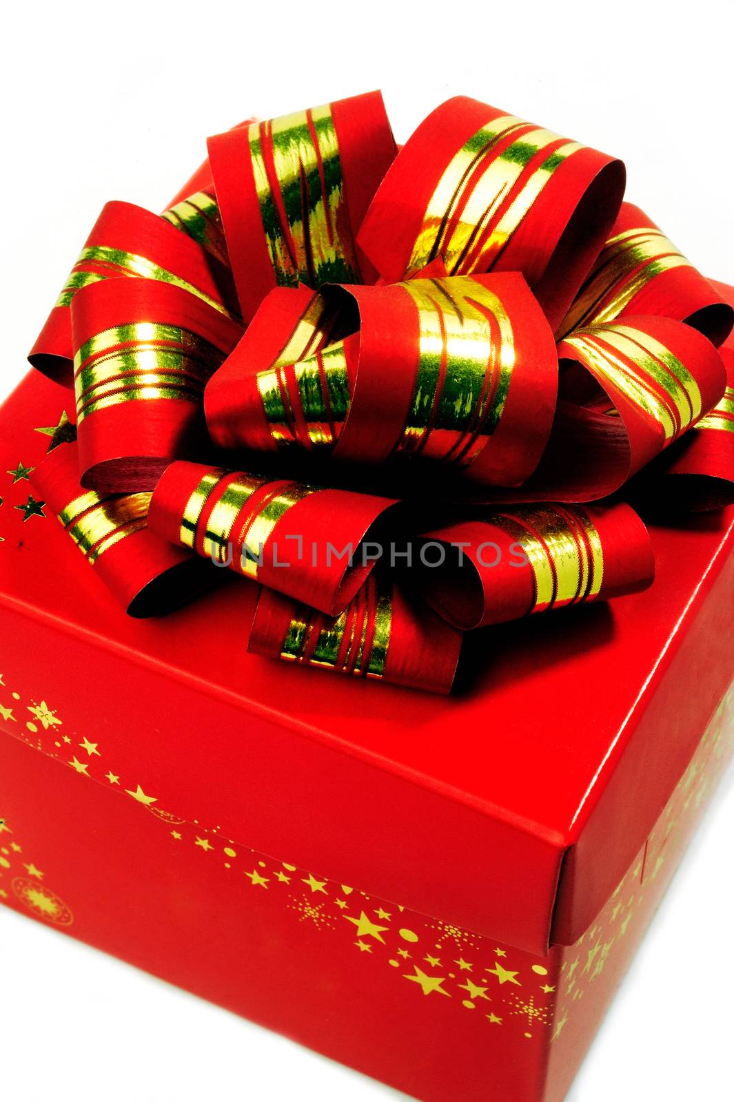 A red gift box with a red bow and gold