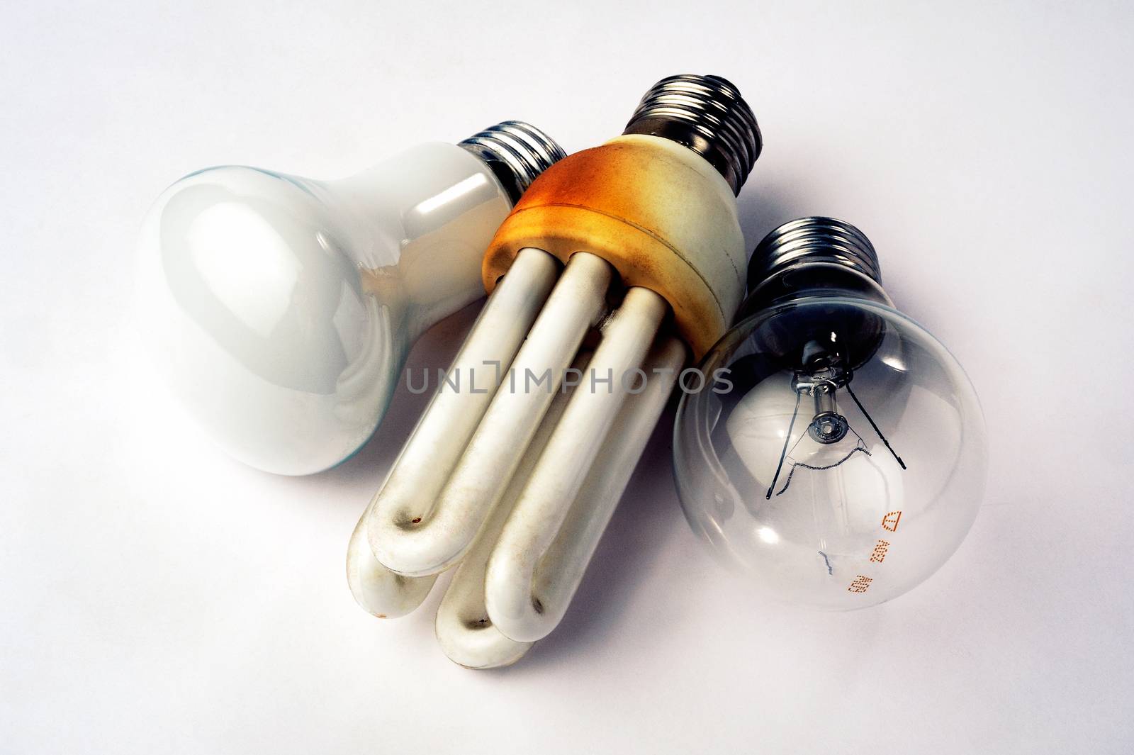 Recycling of used light bulb and economic legacy on white background