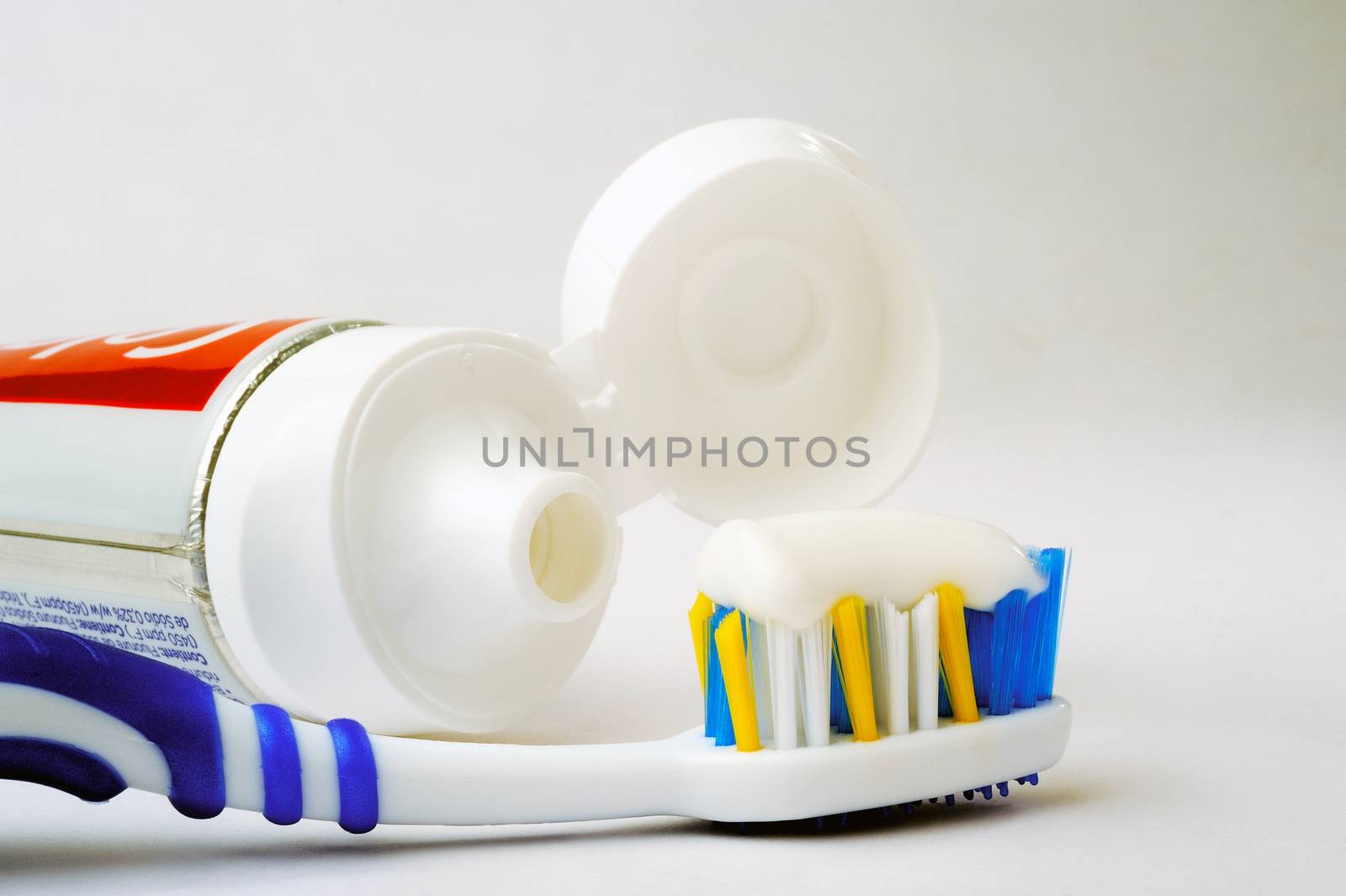 Entire tube of toothpaste with a toothbrush by gillespaire