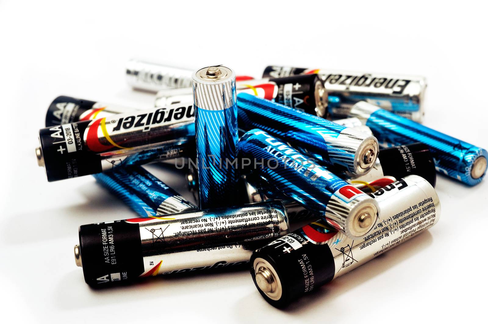 Recycling of used batteries of different brands on white background
