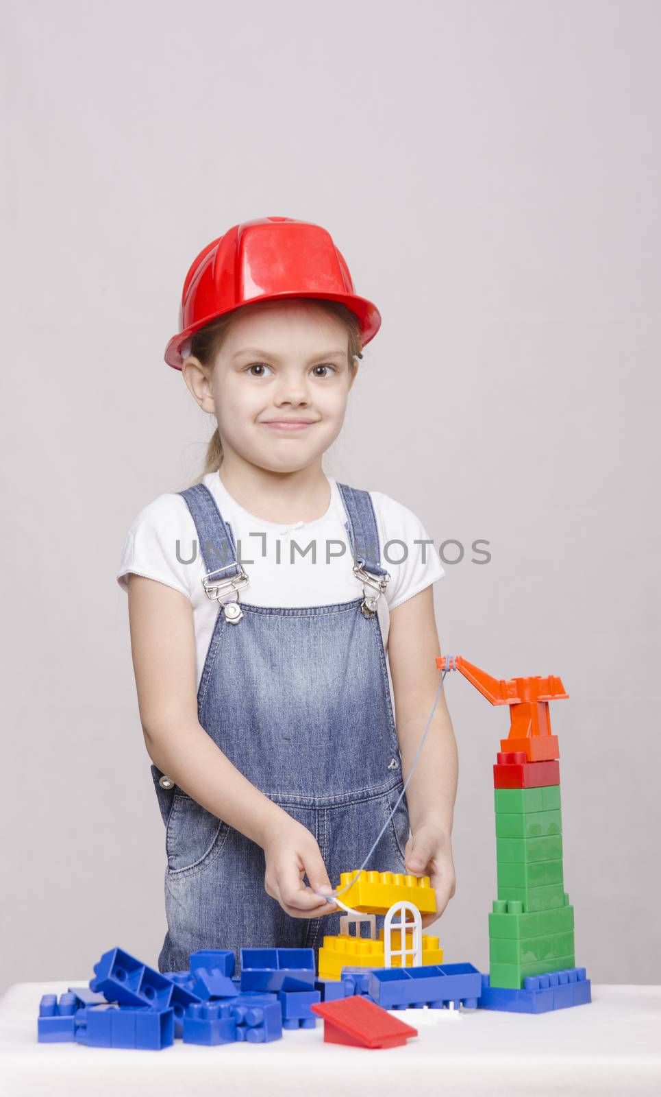 Girl playing in the Builder builds from the designer house.