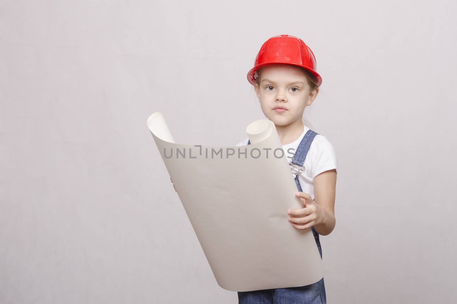 Girl playing Builder launched the drawing up and looks into the drawing