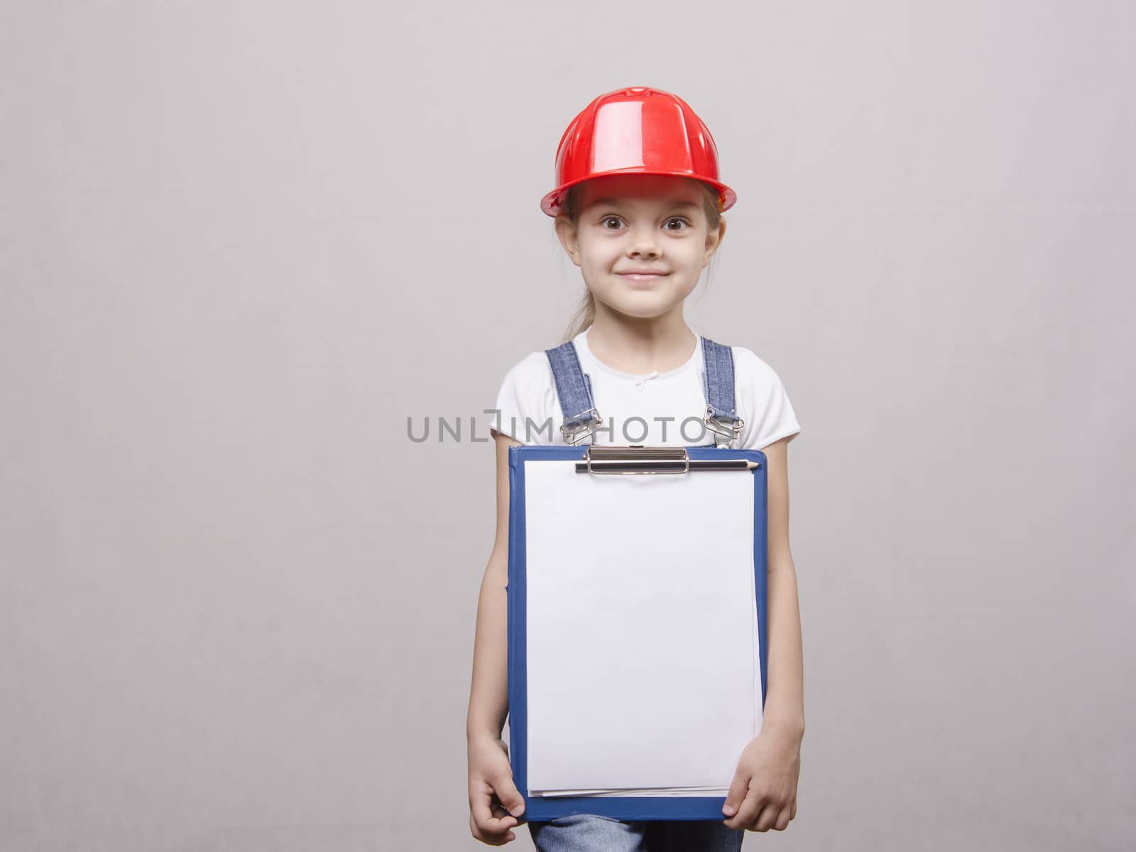Portrait of a child in a helmet and a folder