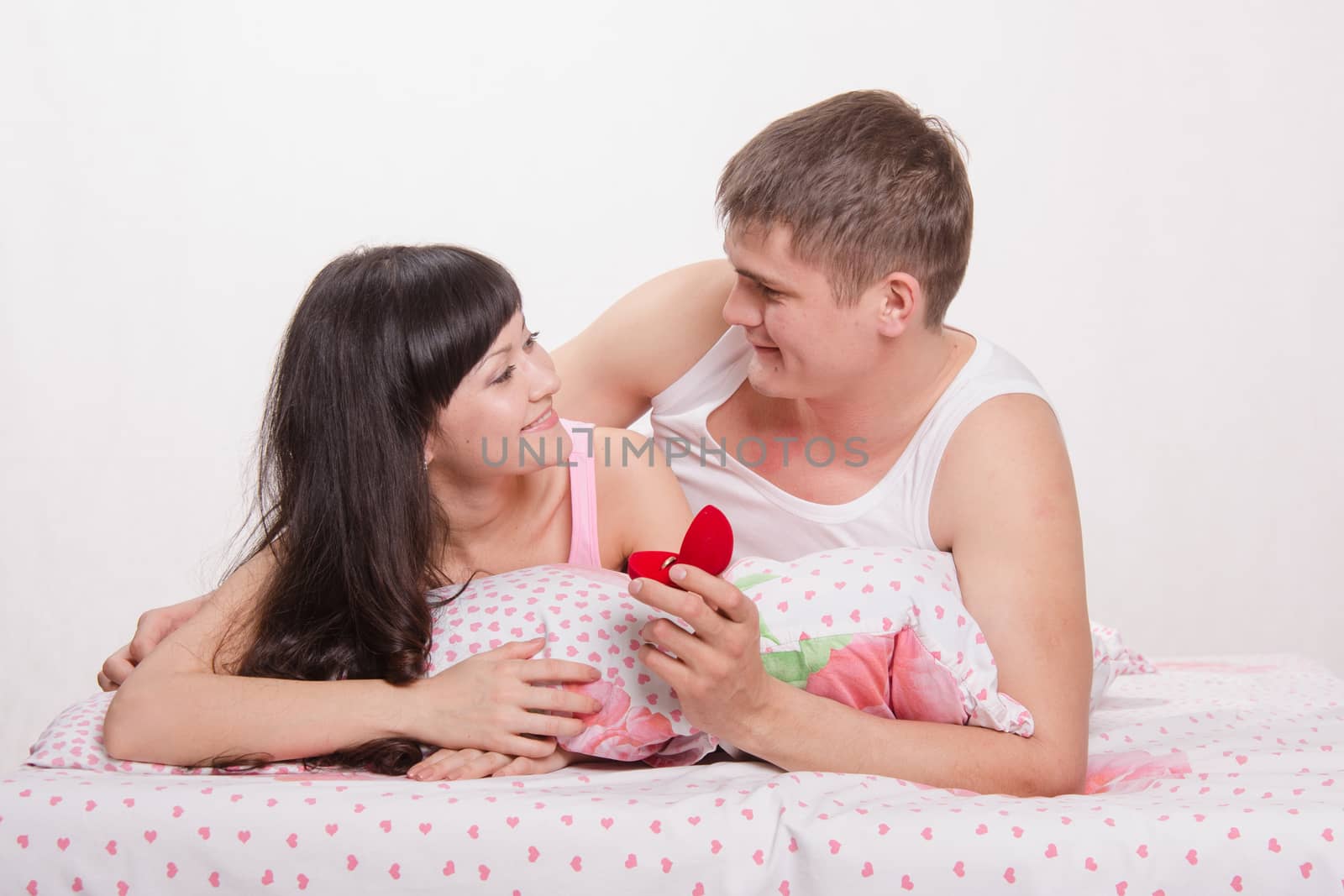 Young man offers the young girl to marry him, and gives a ring