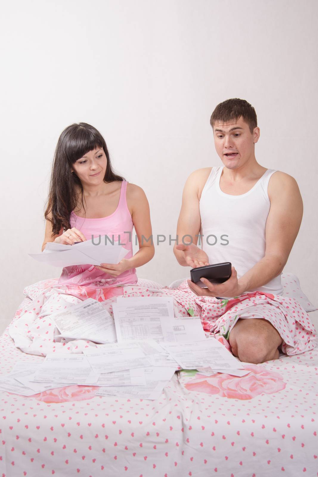 Young beautiful girl and the guy dismantled numerous accounts and bills for rent