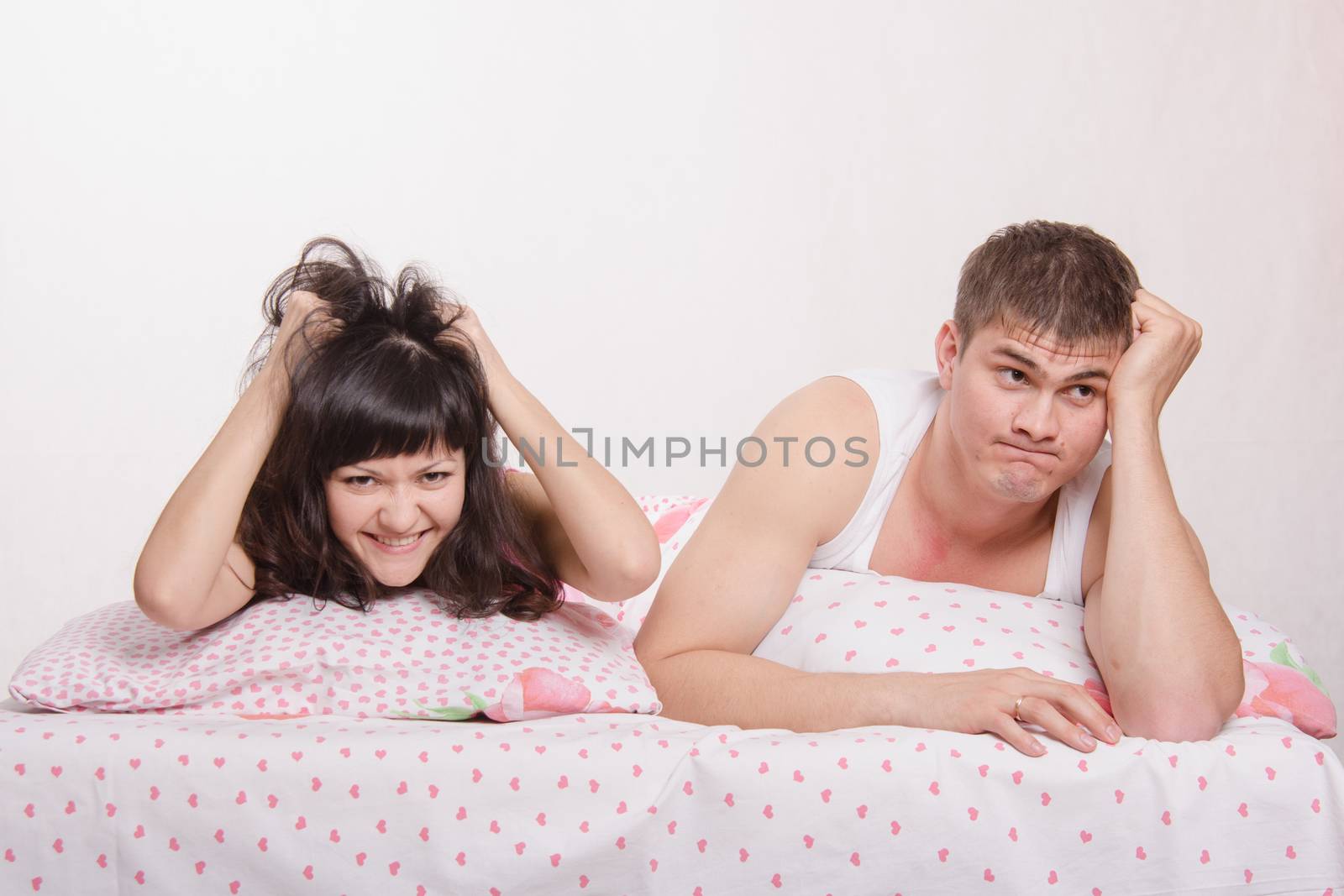 Young couple disappointed missed chance lie in bed