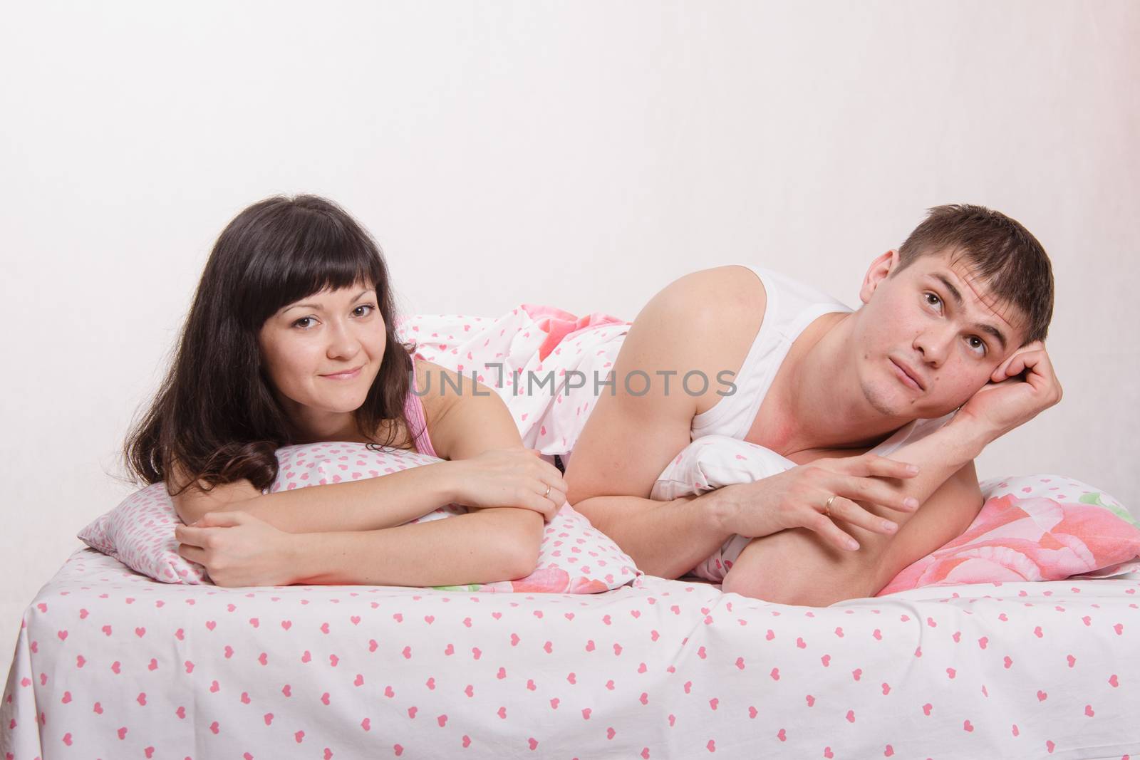 Young couple lying in bed a dreaming