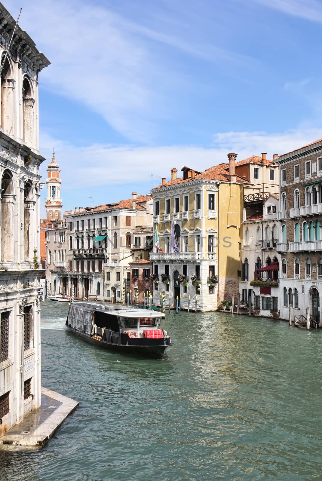 View of the Grand Canal, Italian palaces and a waterbus from Ponte di Rialto or Rialto Bridge in Venice, Italy.