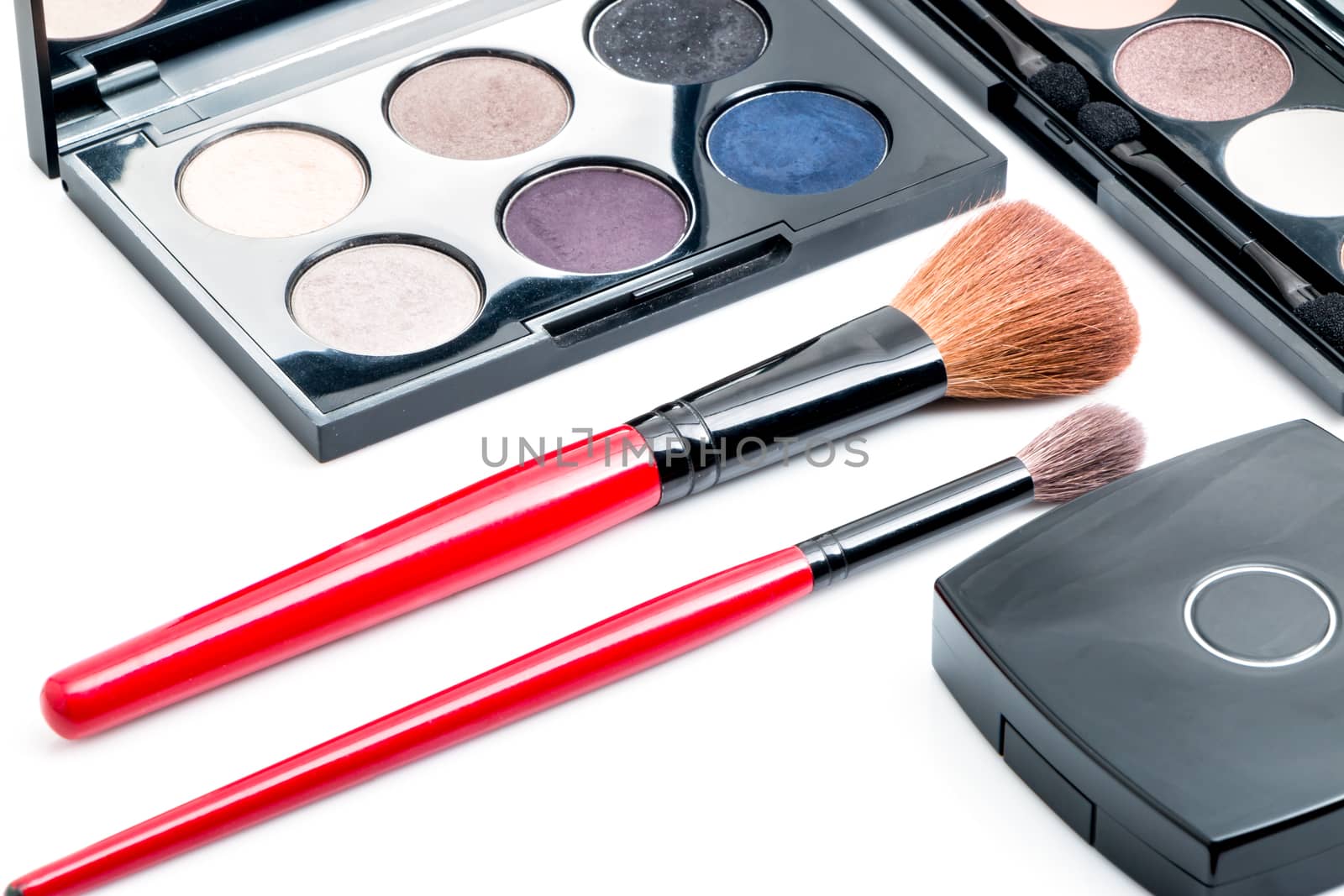 cosmetics and makeup brush, on white background isolated